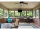 Relaxing screened porch with a ceiling fan, seating, and views of the backyard at 5194 Orahood Ct, Plainfield, IN 46168