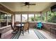 Inviting screened porch featuring a ceiling fan, table, seating, and brick accents at 5194 Orahood Ct, Plainfield, IN 46168