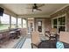 Comfortable screened porch with a ceiling fan, seating, and brick accents at 5194 Orahood Ct, Plainfield, IN 46168