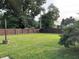 Large backyard featuring a wooden privacy fence and green lawn at 52 S 16Th Ave, Beech Grove, IN 46107