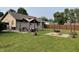 Spacious backyard with green grass, gazebo, firepit, and wooden fence at 52 S 16Th Ave, Beech Grove, IN 46107