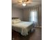 Inviting bedroom featuring a ceiling fan and a comfortable bed with stylish bedding, creating a cozy retreat at 52 S 16Th Ave, Beech Grove, IN 46107