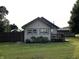 Exterior view of home with a green lawn, mature tree, and charming curb appeal at 52 S 16Th Ave, Beech Grove, IN 46107