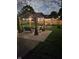 Outdoor gazebo at night, illuminated with string lights, patio, seating, and firepit at 52 S 16Th Ave, Beech Grove, IN 46107