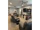 Comfortable living room with stylish furniture, media center, ceiling fan, and carpet at 52 S 16Th Ave, Beech Grove, IN 46107