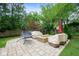 Beautiful backyard with a fire pit, seating, and lush greenery, perfect for entertaining and relaxing at 5425 N Delaware St, Indianapolis, IN 46220