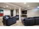 Spacious basement with plush seating, neutral carpet, and a large entertainment center at 5425 N Delaware St, Indianapolis, IN 46220