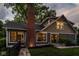 Charming home exterior featuring a well-manicured lawn, brick chimney, and attractive architectural details at 5425 N Delaware St, Indianapolis, IN 46220