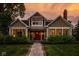 Charming two-story home with a red front door, well-manicured lawn, and inviting walkway at 5425 N Delaware St, Indianapolis, IN 46220
