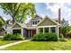 Attractive two-story home featuring a well-maintained lawn, landscaping, and covered entry at 5425 N Delaware St, Indianapolis, IN 46220