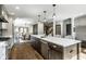 Open kitchen featuring stainless steel appliances, a spacious island, and hardwood floors at 5425 N Delaware St, Indianapolis, IN 46220