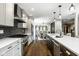 Open kitchen featuring stainless steel appliances, a spacious island, and hardwood floors at 5425 N Delaware St, Indianapolis, IN 46220
