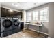 Well-equipped laundry room featuring modern washer and dryer units, and a large window for natural light at 5425 N Delaware St, Indianapolis, IN 46220