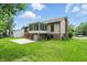 Spacious backyard featuring a patio, screened-in porch, and lush green lawn at 5847 Democracy Dr, Indianapolis, IN 46254