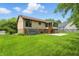 View of the home's exterior featuring a well-kept yard and a screened-in porch at 5847 Democracy Dr, Indianapolis, IN 46254