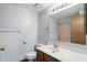 Bathroom featuring a vanity with a white countertop, framed mirror, and a toilet at 5847 Democracy Dr, Indianapolis, IN 46254