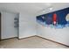 A bedroom featuring a custom space mural, overhead lighting and blue shelving and hooks at 5847 Democracy Dr, Indianapolis, IN 46254