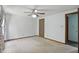Bedroom with neutral carpet, ceiling fan, and light entering through a window at 5847 Democracy Dr, Indianapolis, IN 46254