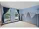 Bright bedroom with mountain mural, carpet flooring, and natural light from two windows at 5847 Democracy Dr, Indianapolis, IN 46254