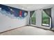 A neutrally decorated bedroom with a space themed feature wall with two windows and neutral carpet at 5847 Democracy Dr, Indianapolis, IN 46254