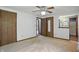 Bedroom featuring neutral carpet, with three doors, with a view to a bathroom at 5847 Democracy Dr, Indianapolis, IN 46254