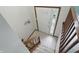 Welcoming foyer features tile flooring, a staircase with wooden railing, and a front door with sidelight at 5847 Democracy Dr, Indianapolis, IN 46254