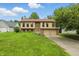 Beautiful home featuring brick and siding, an attached two-car garage, and a well-manicured lawn at 5847 Democracy Dr, Indianapolis, IN 46254