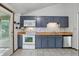Spacious kitchen with gray cabinets, tile floors, and views of the backyard at 5847 Democracy Dr, Indianapolis, IN 46254