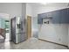 Bright kitchen with stainless steel refrigerator, tile floors, and breakfast nook at 5847 Democracy Dr, Indianapolis, IN 46254