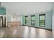 Bright open concept space featuring wood-look floors, neutral walls, staircase and large windows at 5847 Democracy Dr, Indianapolis, IN 46254