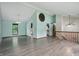 Open living area features wood-look flooring, high ceilings, large windows, and modern lighting at 5847 Democracy Dr, Indianapolis, IN 46254