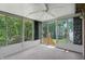 Bright sunroom with a ceiling fan and multiple large windows offering scenic backyard views at 5847 Democracy Dr, Indianapolis, IN 46254