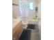 Standard bathroom with white tile and updated fixtures; shower over tub at 623 Chariot Ln, Indianapolis, IN 46227