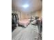 Cozy bedroom with grey floors, pink bedding, and a full set of modern furniture at 623 Chariot Ln, Indianapolis, IN 46227
