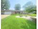 Charming brick ranch home with well-manicured lawn and colorful flowerbeds at 623 Chariot Ln, Indianapolis, IN 46227