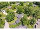 Aerial view shows lush greenery surrounding a beautiful home with an inviting driveway and detached garage at 6337 Cardinal Ln, Indianapolis, IN 46220