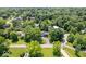 Aerial view of homes nestled within mature trees, showcasing established landscaping and well-maintained lawns at 6337 Cardinal Ln, Indianapolis, IN 46220