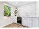 Chic bar area features white cabinets, marble backsplash, mini fridge, and a bright window at 6337 Cardinal Ln, Indianapolis, IN 46220