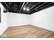 Unfinished basement shows open ceiling with room for storage and updated floors at 6337 Cardinal Ln, Indianapolis, IN 46220