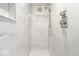Modern shower features marble tile, a rainfall showerhead, and sleek fixtures at 6337 Cardinal Ln, Indianapolis, IN 46220