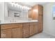 Bathroom with double vanities, ample counter space, and natural wood cabinetry at 6337 Cardinal Ln, Indianapolis, IN 46220