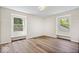 Bright bedroom with wood floors, white walls, and natural light from two windows at 6337 Cardinal Ln, Indianapolis, IN 46220
