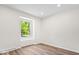 Empty bedroom with hardwood floors and a bright window providing natural light at 6337 Cardinal Ln, Indianapolis, IN 46220
