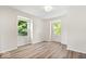 Bright bedroom with wood floors, white walls, and natural light from two windows at 6337 Cardinal Ln, Indianapolis, IN 46220