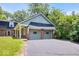 Two car detached garage with brick accents with paved driveway for easy access and curb appeal at 6337 Cardinal Ln, Indianapolis, IN 46220