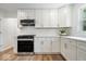 Elegant kitchen showcasing white cabinetry, granite countertops, and stainless steel appliances at 6337 Cardinal Ln, Indianapolis, IN 46220