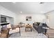Cozy living room with contemporary furnishings, stylish rug, and updated floors at 6337 Cardinal Ln, Indianapolis, IN 46220