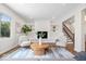 Bright living room with a fireplace, built-in shelving, and a staircase nearby at 6337 Cardinal Ln, Indianapolis, IN 46220
