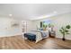 Spacious main bedroom with hardwood floors, a blue accent bench, and ample natural light at 6337 Cardinal Ln, Indianapolis, IN 46220