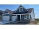 Charming blue home featuring white trim accents and a two-car garage, blending modern style and classic appeal at 6367 Stone Side Dr, Plainfield, IN 46168